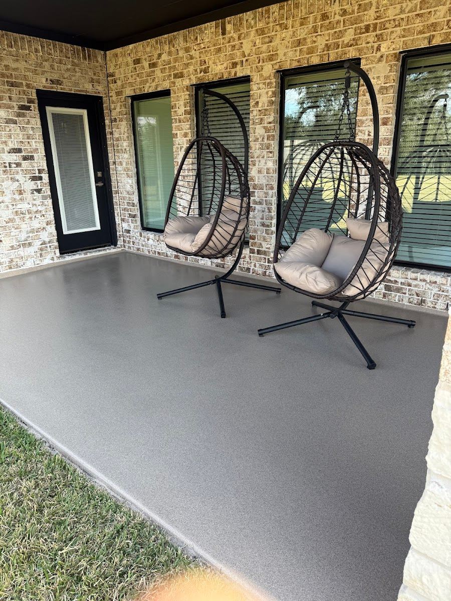 Gray flake epoxy patio coating at a brick Texas home